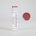 A brassy tinted lip balm with pink undertones, infused with beeswax and botanical oils for hydration.